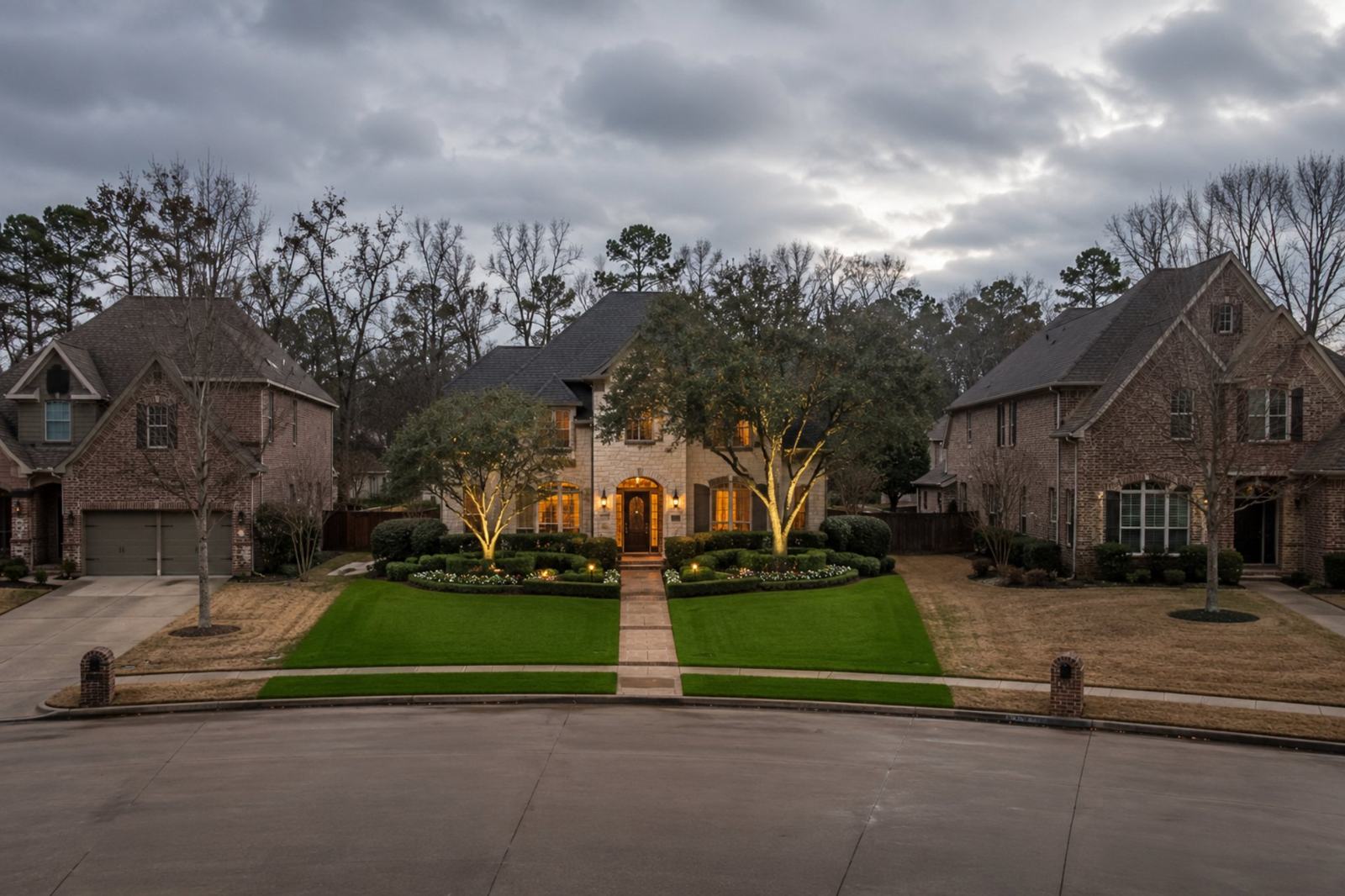 A Super Grass lawn, deep green and striped, between two neighboring lawns gone brown and dormant for winter